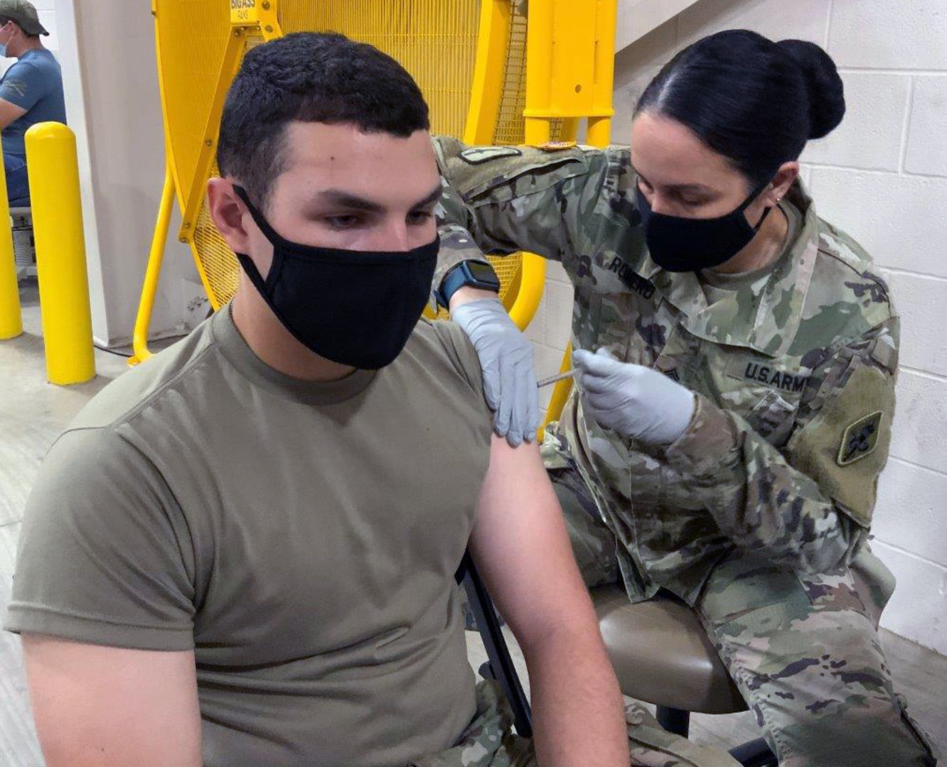Pvt. Michael Giuffrida, a 68K medical laboratory specialist in training at the U.S. Army Medical Center of Excellence, or MEDCoE, is administered the first dose of the Pfizer BioNTech COVID-19 vaccine by Sgt. 1st Class Victoria Romero, MEDCoE 68W Combat Medic cadre augmenting staff, at the Brooke Army Medical Center’s Joint Base San Antonio-Fort Sam Houston Vaccine site April 15.