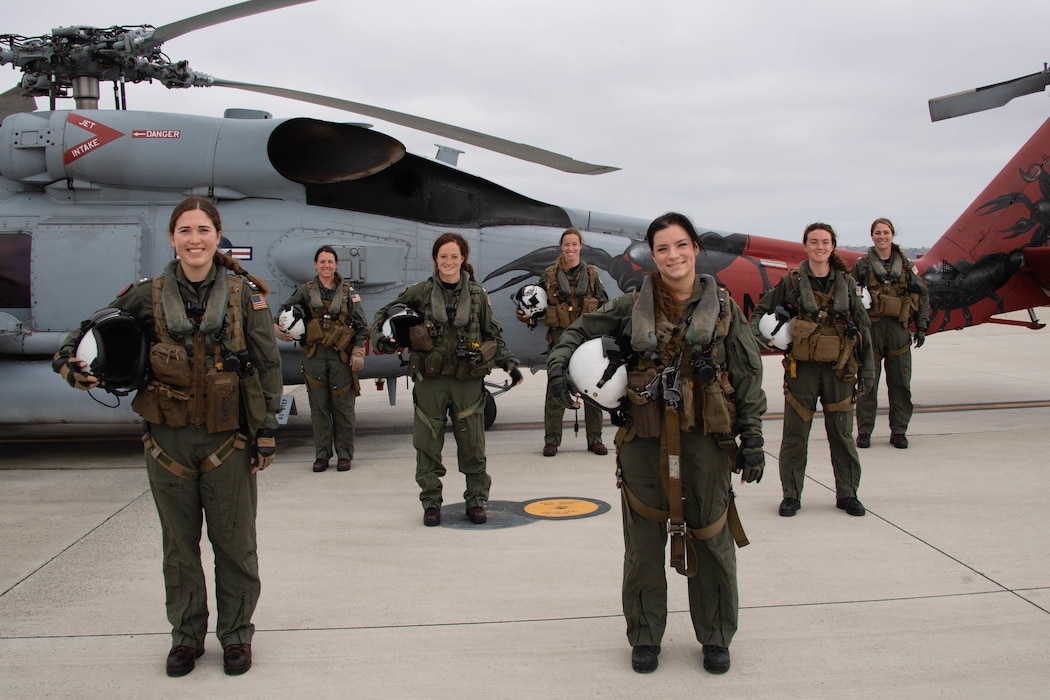 Navy pilots and aircrew pose for a photo before taking off on the first all-female crew MH-60R Sea Hawk training flight.