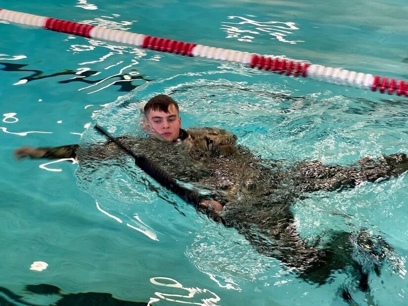 soldier in water doing water survival training