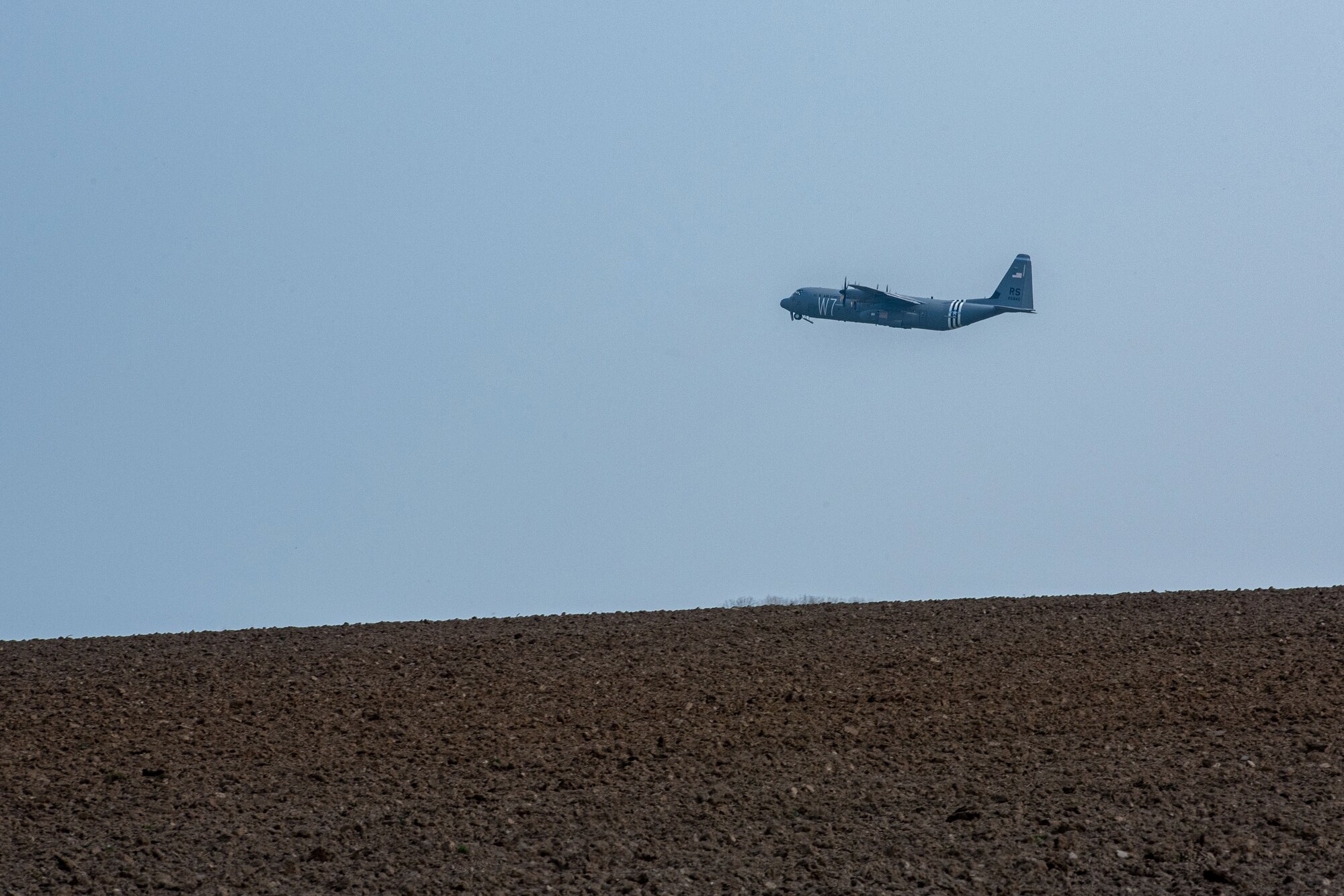 A C-130 taking off from an airfield