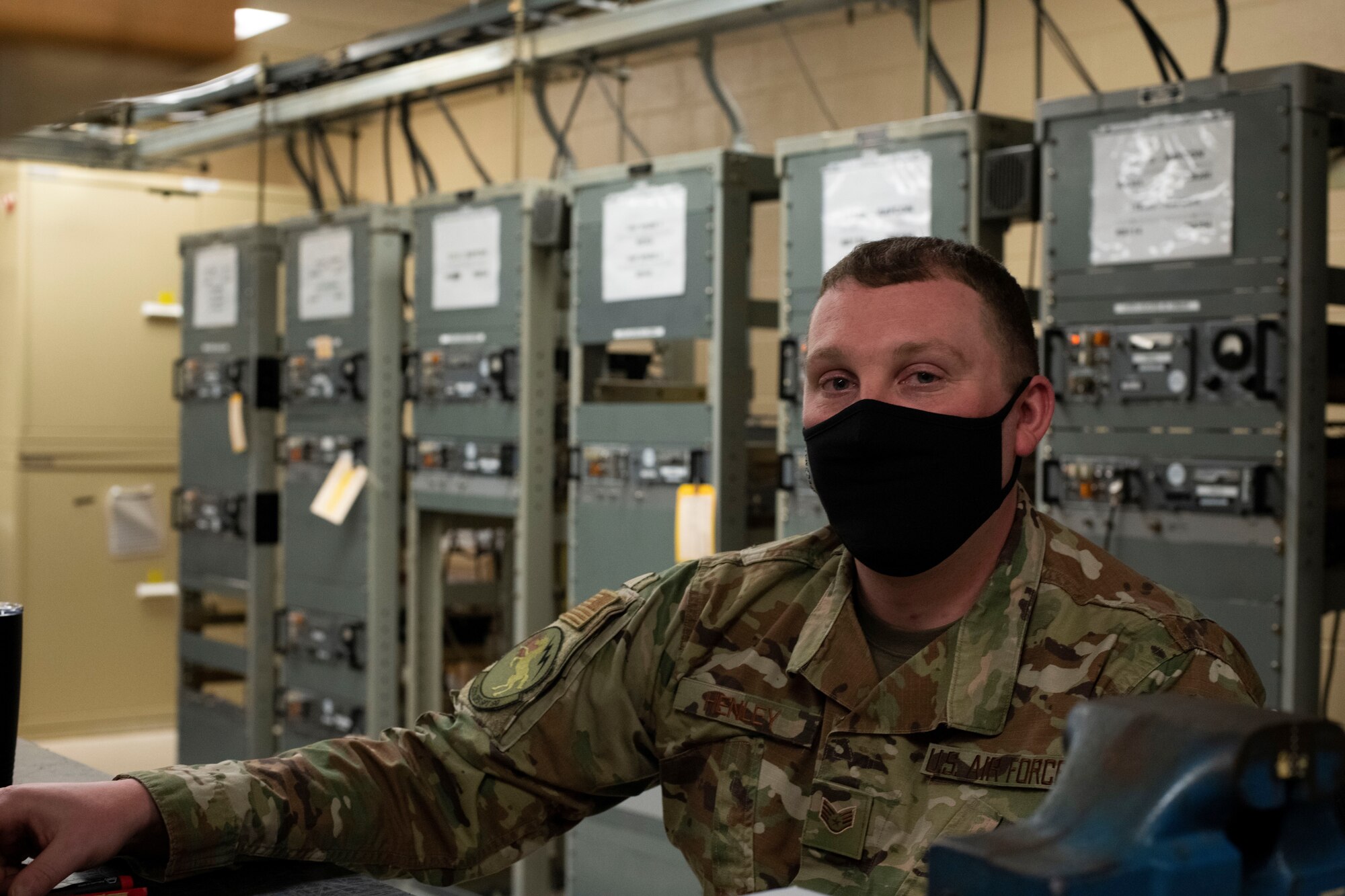 SSgt Richard Henley sits in front of radio equipment.