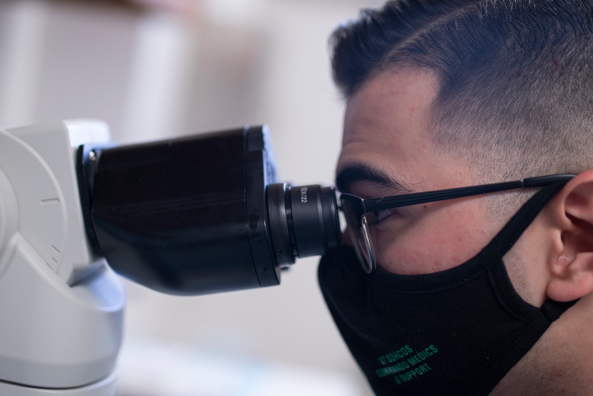 Senior Airman Charson Ashcraft, a laboratory technician assigned to the 27th Special Operations Healthcare Operations Squadron, looks through a microscope to perform a blood count at Cannon Air Force Base, N.M., April 12, 2021. Lab technicians perform duties such as blood counts in order to ensure the health and safety of the Air Force's number one priority, Airmen and their dependents. (U.S. Air Force photo by Airman 1st Class Christopher Storer)