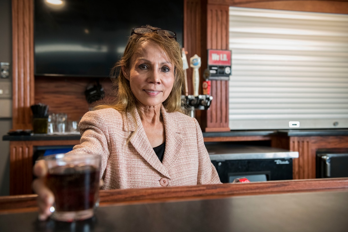 Vacharin “Charlie” Panboon Bedesem, Charlie’s Lounge bartender, serves a drink March 8, 2021, at Altus Air Force Base, Oklahoma. Aside from working at the lounge, Charlie has a job as a florist in the City of Altus. (U.S. Air Force photo by Airman 1st Class Amanda Lovelace)