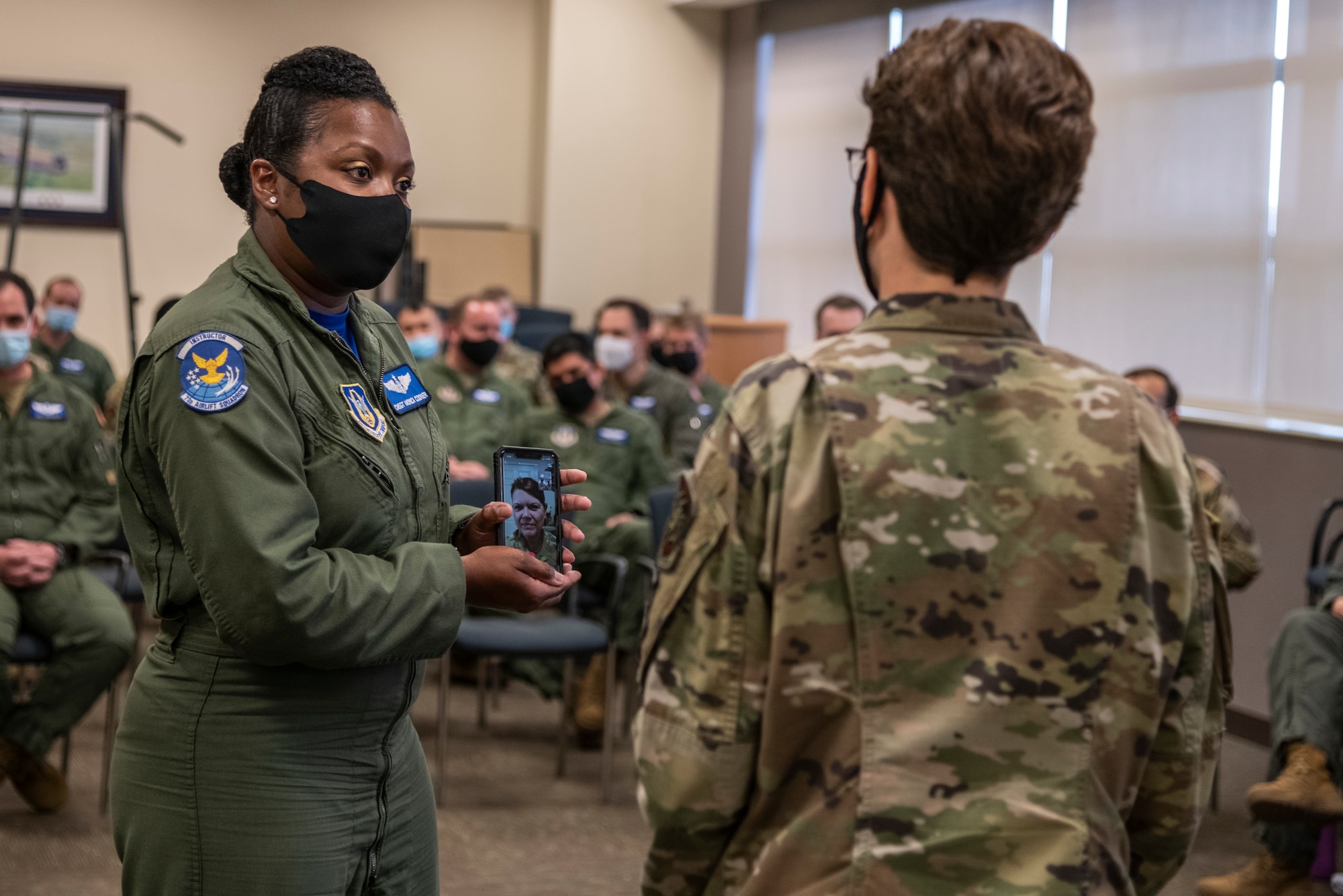 U.S. Air Force Gen. Jacqueline Van Ovost, Air Mobility Command commander, recognizes Tech. Sgt. Ginger Stewart, 73 Airlift Squadron, flight attendant, as a star performer from the 932nd Airlift Wing, on April 10, 2021. Chief Master Sgt. Monica Codner, 73 Airlift Squadron, superintendent, nominated Stewart for her outstanding work. (U.S. Air Force photo by Senior Airman Brooke Spenner)
