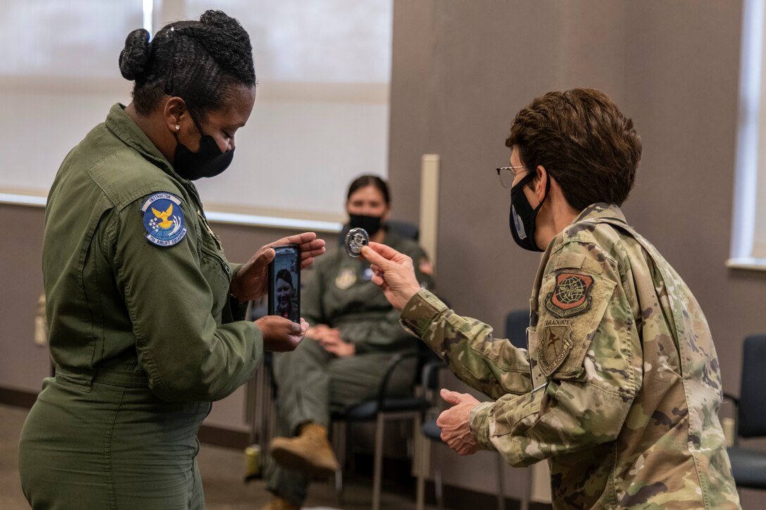 U.S. Air Force Gen. Jacqueline Van Ovost, Air Mobility Command commander, recognizes Tech. Sgt. Ginger Stewart, 73 Airlift Squadron, flight attendant, as a star performer from the 932nd Airlift Wing, on April 10, 2021. Chief Master Sgt. Monica Codner, 73 Airlift Squadron, superintendent, nominated Stewart for her outstanding work. (U.S. Air Force photo by Senior Airman Brooke Spenner)