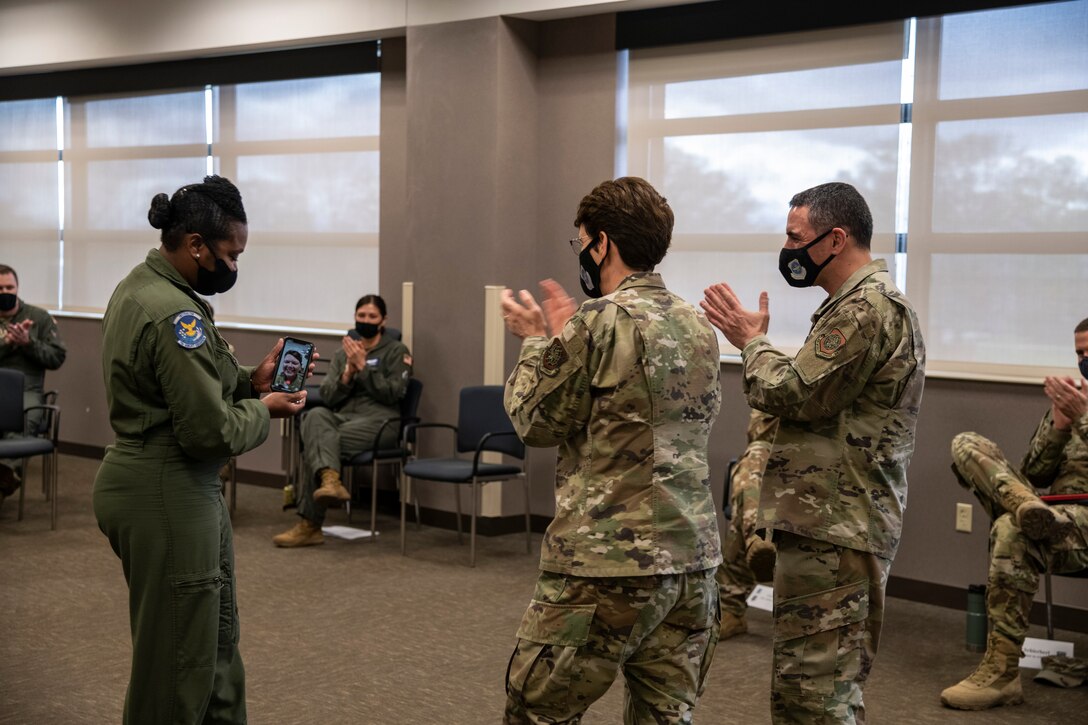 U.S. Air Force Gen. Jacqueline Van Ovost, Air Mobility Command commander, recognizes Tech Sgt. Ginger Stewart, 73 Airlift Squadron, flight attendant, as a star performer from the 932nd Airlift Wing, on April 10, 2021. Chief Master Sgt. Monica Codner, 73 Airlift Squadron, superintendent, nominated Stewart for her outstanding work. (U.S. Air Force photo by Senior Airman Brooke Spenner)