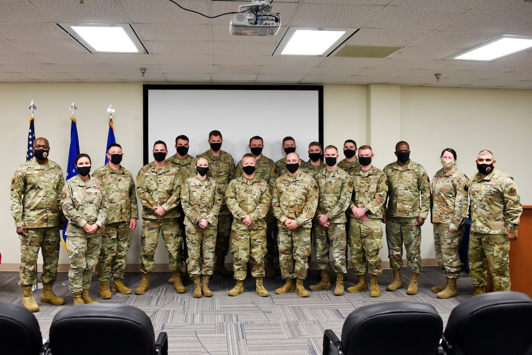 Wing, group and squadron level leadership pose for a photo with the newest graduates of the Aircraft Maintenance Officers Course at Sheppard Air Force Base, Texas, April 22, 2021