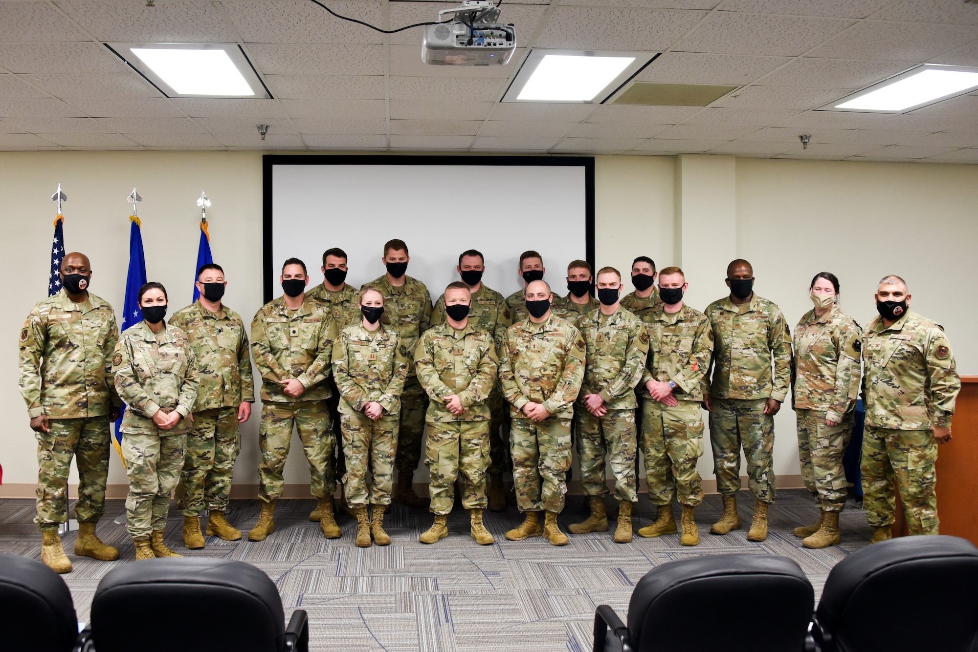 Wing, group and squadron level leadership pose for a photo with the newest graduates of the Aircraft Maintenance Officers Course at Sheppard Air Force Base, Texas, April 22, 2021