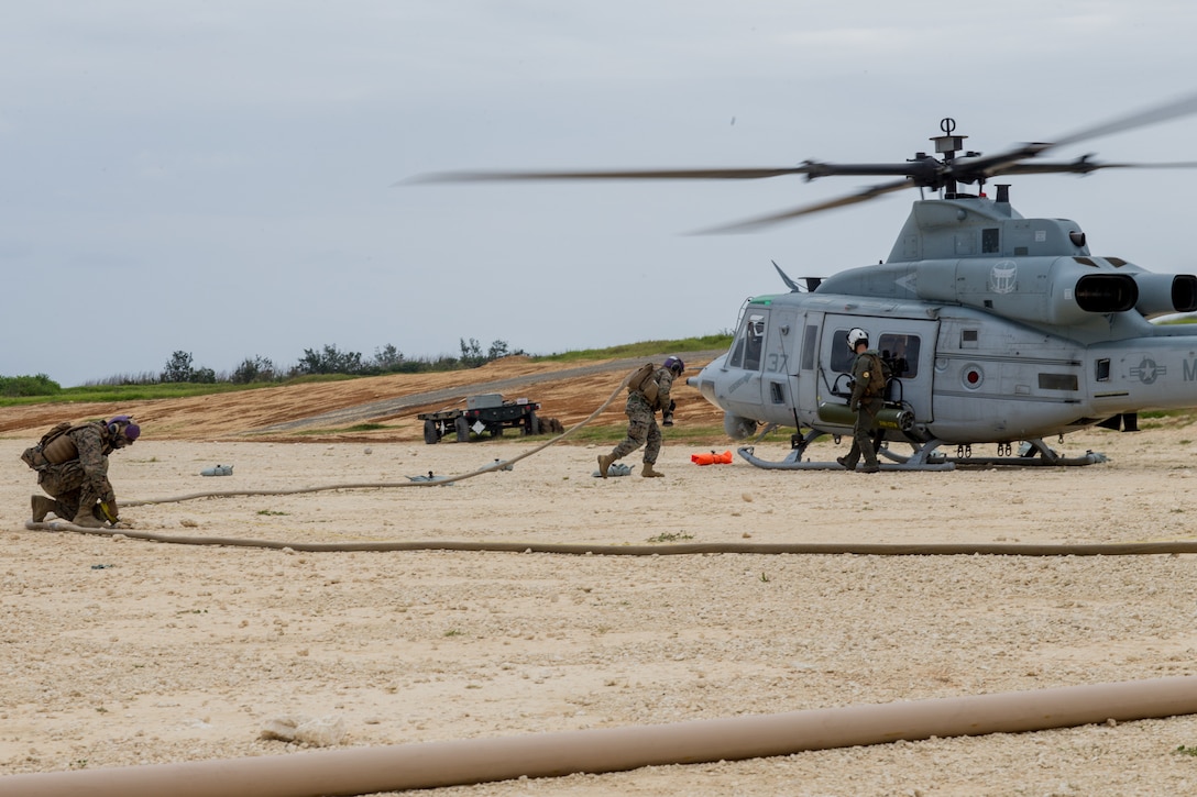 U.S. Marines with Marine Wing Support Squadron 172 prepare to refuel a UH-1Y Venom helicopter assigned to Marine Light Helicopter Squadron 267 during a forward arming and refueling point training event as part of a Marine Corps combat readiness evaluation held by MWSS-172 at the Ie Shima training facility, Okinawa, Japan, April 15, 2021. The MCCRE creates a challenging, realistic training environment that produces combat-ready forces capable of operating as a deployed unit at any time.