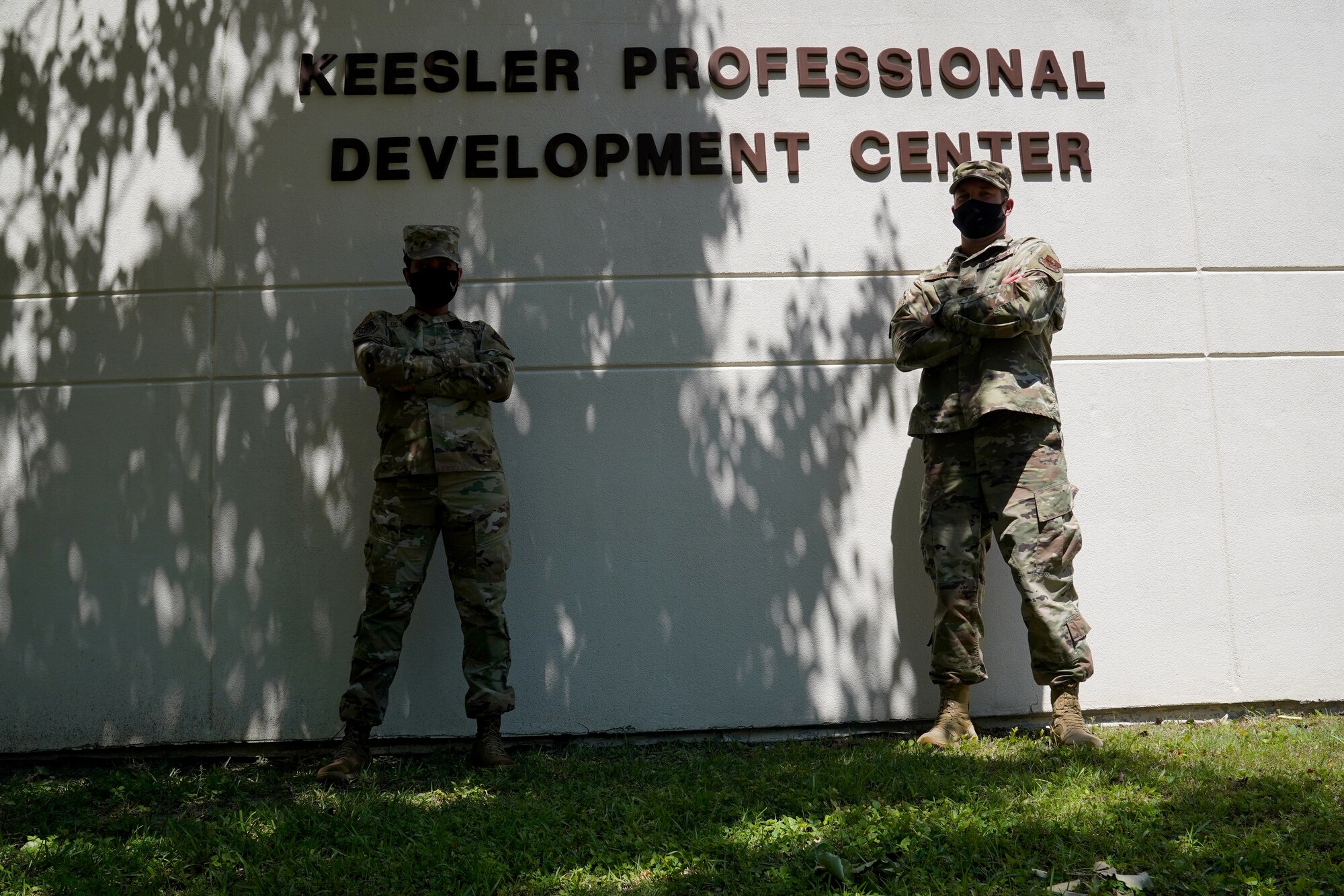 U.S. Air Force Master Sgt. Shenelka De Gannes, 81st Training Wing career assistance advisor, and Tech Sgt. Jason Repass, 81st TRW First-term Airman Course NCO in charge, pose for a photo in front of the Professional Development Center at Keesler Air Force Base, Mississippi, April 22, 2021. The PDC provides personal and professional development opportunities for service members. (U.S. Air Force photo by Senior Airman Seth Haddix)