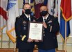 Brig. Gen. Michael Lalor, left, commander of Army Medical Logistics Command, presents Chief Warrant Officer 5 Jesus C. Tulud with his certificate of retirement from the U.S. Army during a ceremony April 15 at Fort Detrick, Maryland. (Photo Credit: C.J. Lovelace)