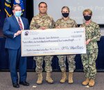 JBSA leaders with mock check.