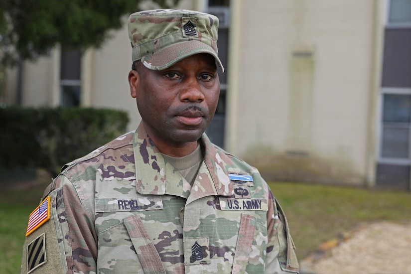 A soldier in uniform poses for a photo.