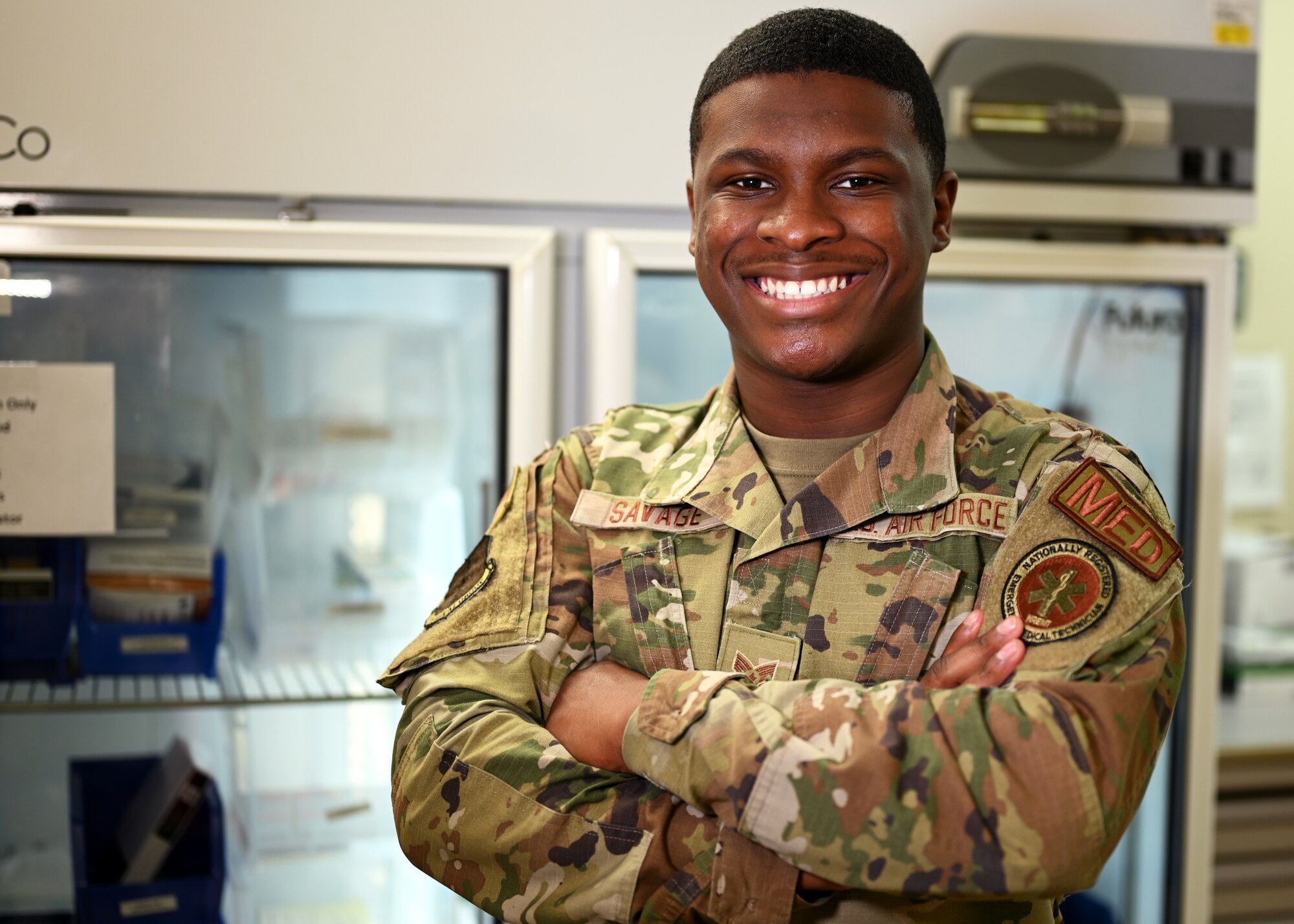 U.S. Air Force Senior Airman Micah Savage, 17th Medical Group immunizations technician, poses in front of his equipment at the Ross Clinic on Goodfellow Air Force Base, Texas, April 19, 2021. Savage played an important role in ensuring that immunizations are administered properly to 17th MDG patients. (U.S. Air Force photo by Airman 1st Class Michael Bowman)