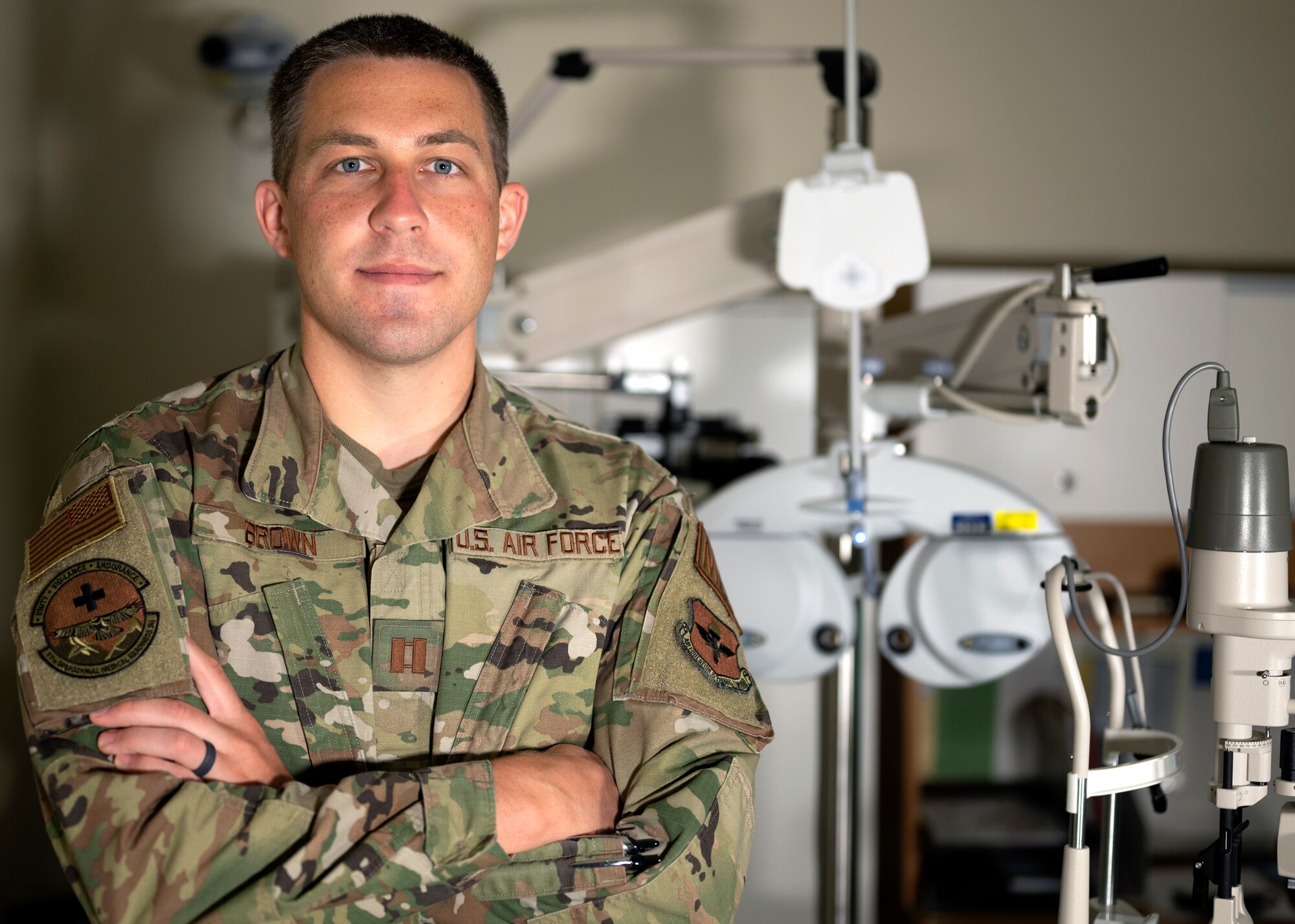 U.S. Air Force Capt. Paul Brown, 17th Medical Group optometry element chief, poses in front of his equipment at the Ross Clinic on Goodfellow Air Force Base, Texas, April 19, 2021. Brown serviced more than a thousand Goodfellow community members as the sole optometrist at the 17th MDG.  (U.S. Air Force photo by Airman 1st Class Michael Bowman)