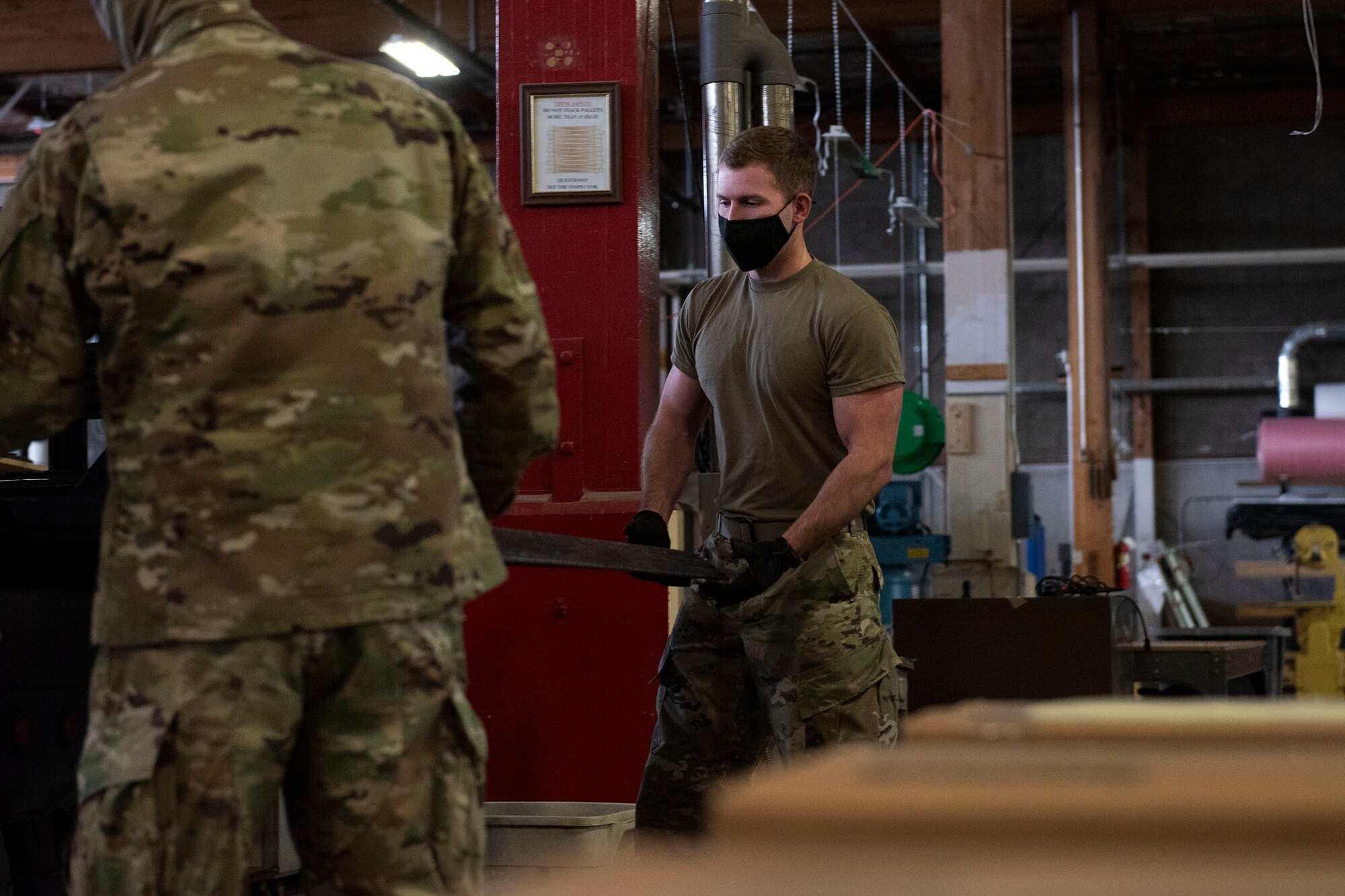 Airman 1st Class Orion Jones, 341st Logistics Readiness Squadron vehicle operator, loads packaged materials into a delivery truck in the cargo hangar April 12, 2021, on Malmstrom Air Force Base, Mont.