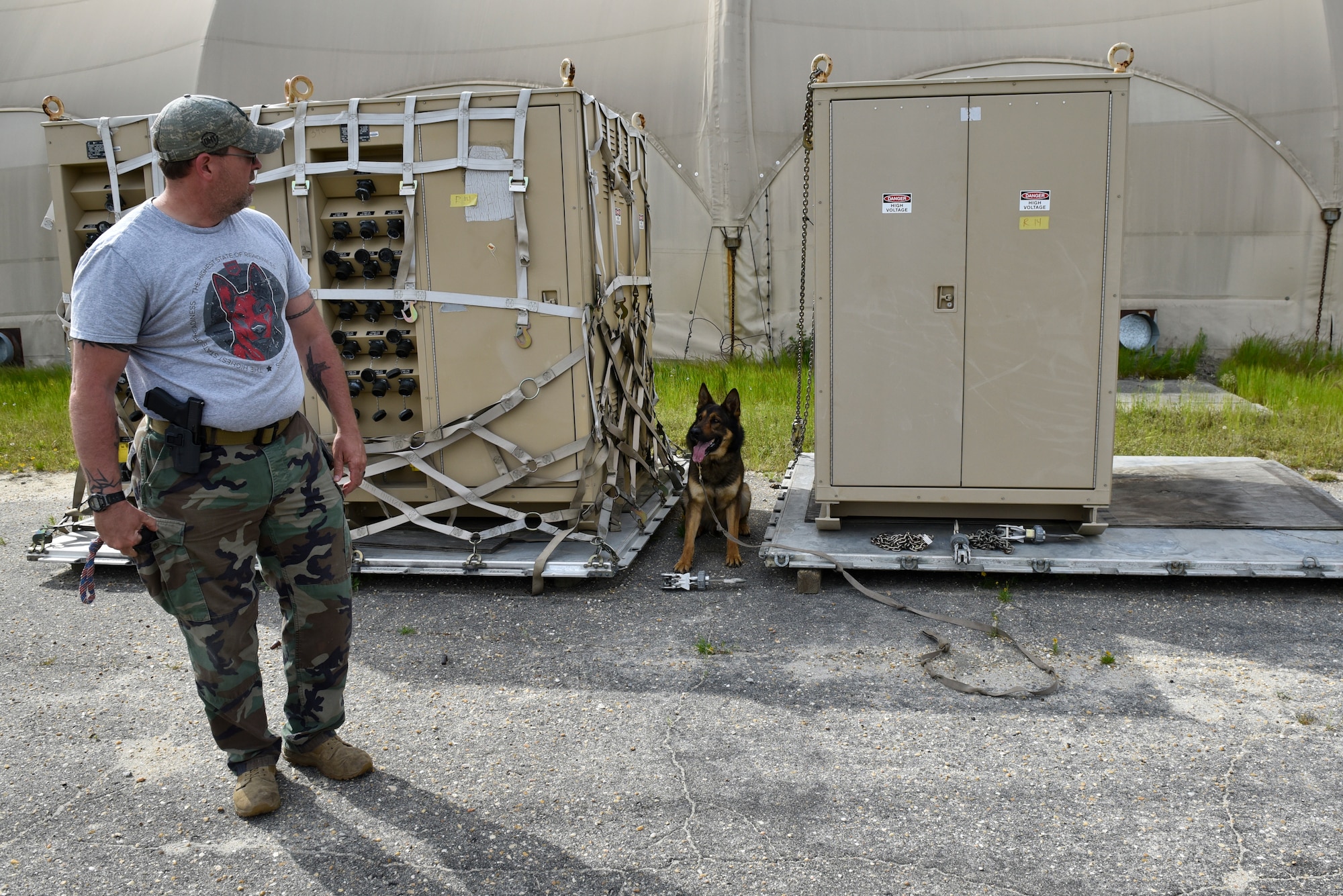 Koda, East Carolina University Police Department explosives detection canine, signals to Dave Heath, ECUPD canine handler, that he found explosive material during a joint interagency training day at Seymour Johnson Air Force Base, North Carolina, April 20, 2021. Heath and Koda regularly visit Team Seymour to train with the 4th Security Forces Squadron Military Working Dog section. (U.S. Air Force photo by Staff Sgt. Kenneth Boyton)