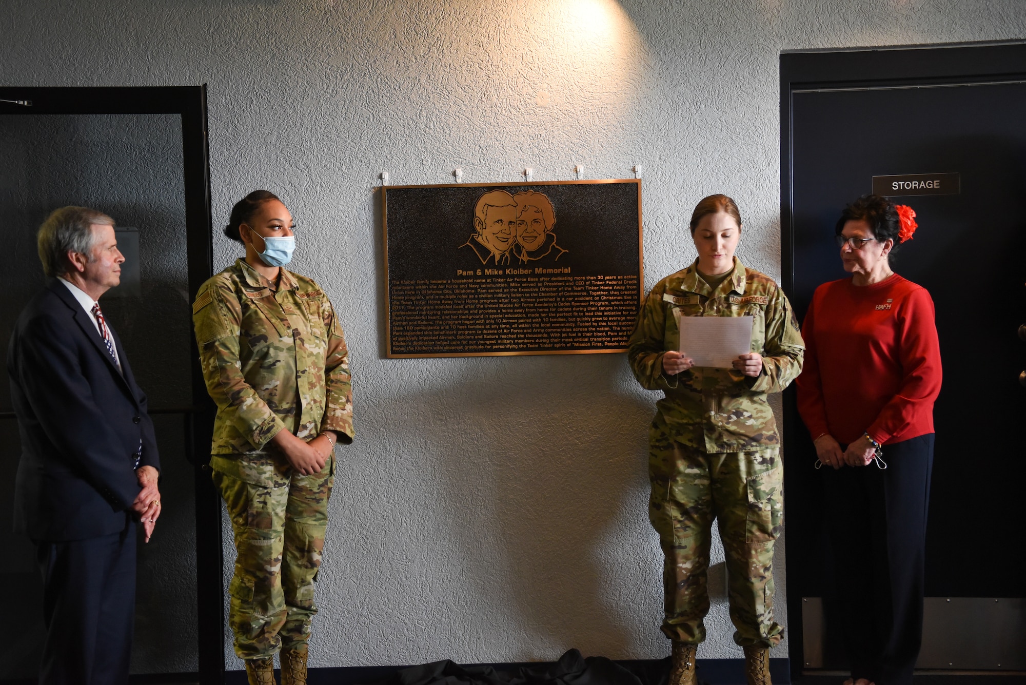 Four people standing around a plaque that had just been unveiled.