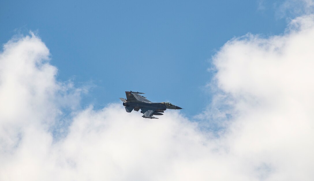 A photo of an F-16 Viper flying in the sky.