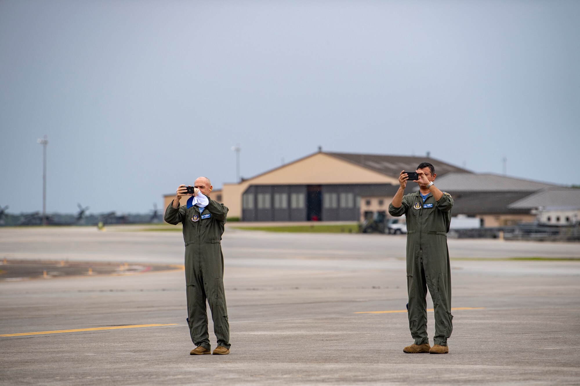 A photo of Airmen taking video of aircraft