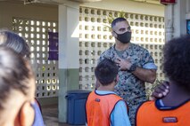 U.S. Marine Corps Col. Speros Koumparakis, commanding officer, Marine Corps Base Hawaii, speaks with students as they arrive to Mokapu Elementary school, Marine Corps Base Hawaii, April 22, 2021. Parents and family members cheered for students as they were dropped off for class as a way to support them and celebrate the Month of the Military Child. (U.S. Marine Corps photo by Marine Corps Base Hawaii Communication Strategy and Operations)