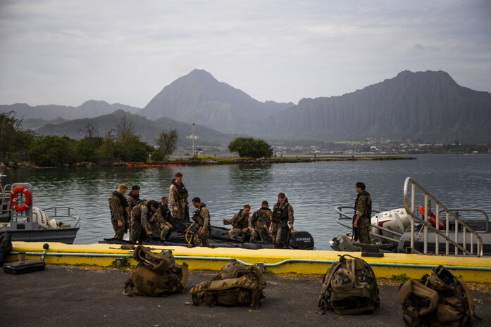 U.S. Marines in the Recon Leaders Course prepare their gear prior to conducting a helocast training event, Marine Corps Base Hawaii, April 20, 2021. The purpose of the training is to teach Marines how to insert into a body of water from an air asset. (U.S. Marine Corps photo by Lance Cpl. Brandon Aultman)
