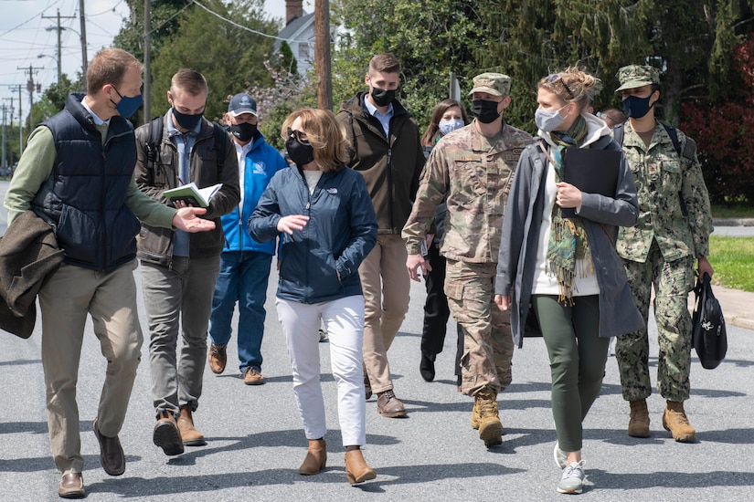 A group of people walk outdoors.