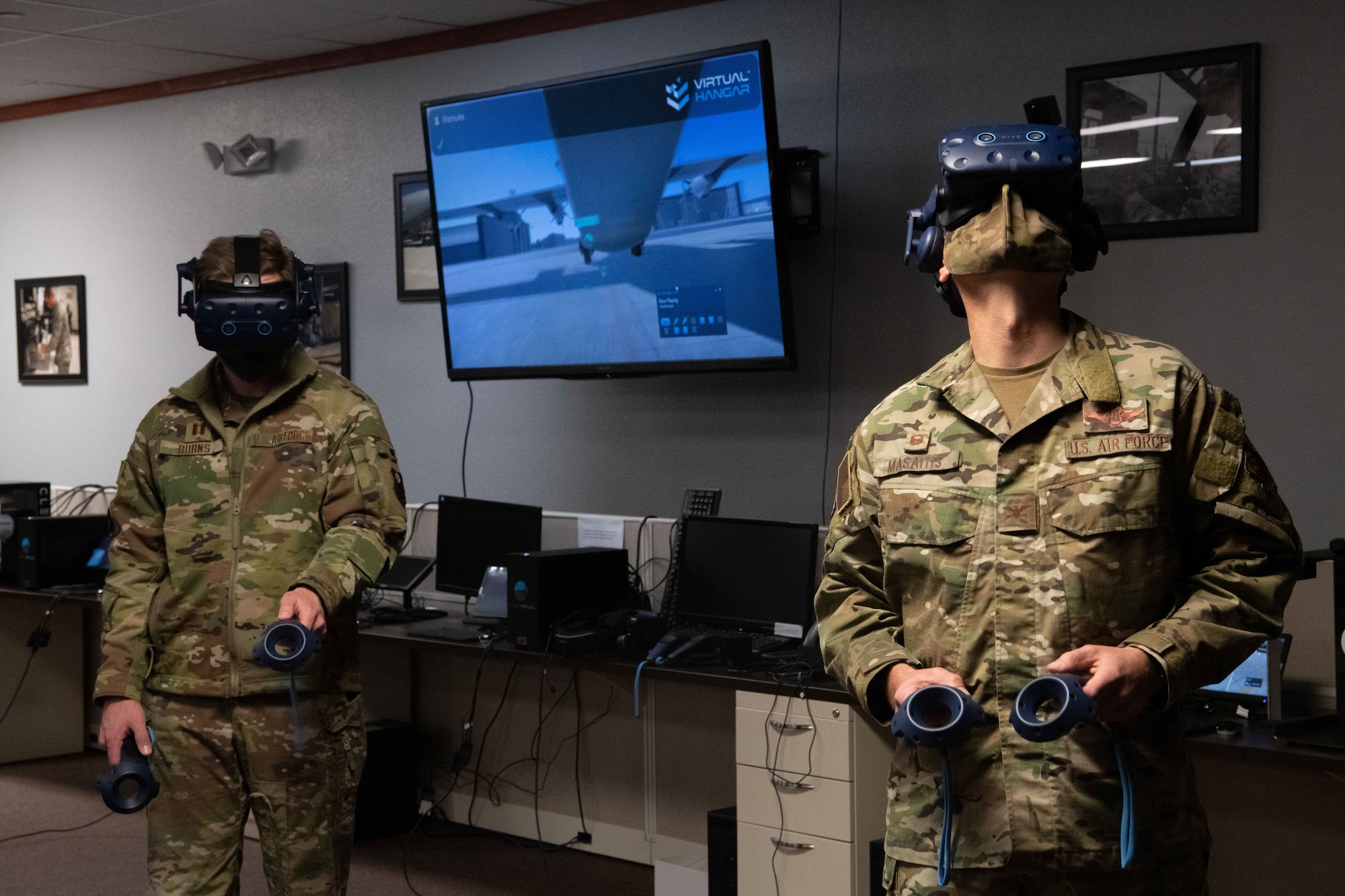 U.S. Air Force Capt. Peter Burns, 20th Special Operations Squadron CV-22 Osprey pilot, and U.S. Air Force Col. Robert Masaitis, 27th Special Operations Wing commander, experience an MC-130J Commando II aircraft virtual reality maintenance training program during an Air Education and Training Command Integrated Technology Platform demonstration April 15, 2021, at Cannon Air Force Base, N.M. Event coordinators introduced Cannon leaders to acquisition contractors and discussed how to get fully operational training programs assimilated into squadrons. (U.S. Air Force photo by Staff Sgt. Peter Reft)