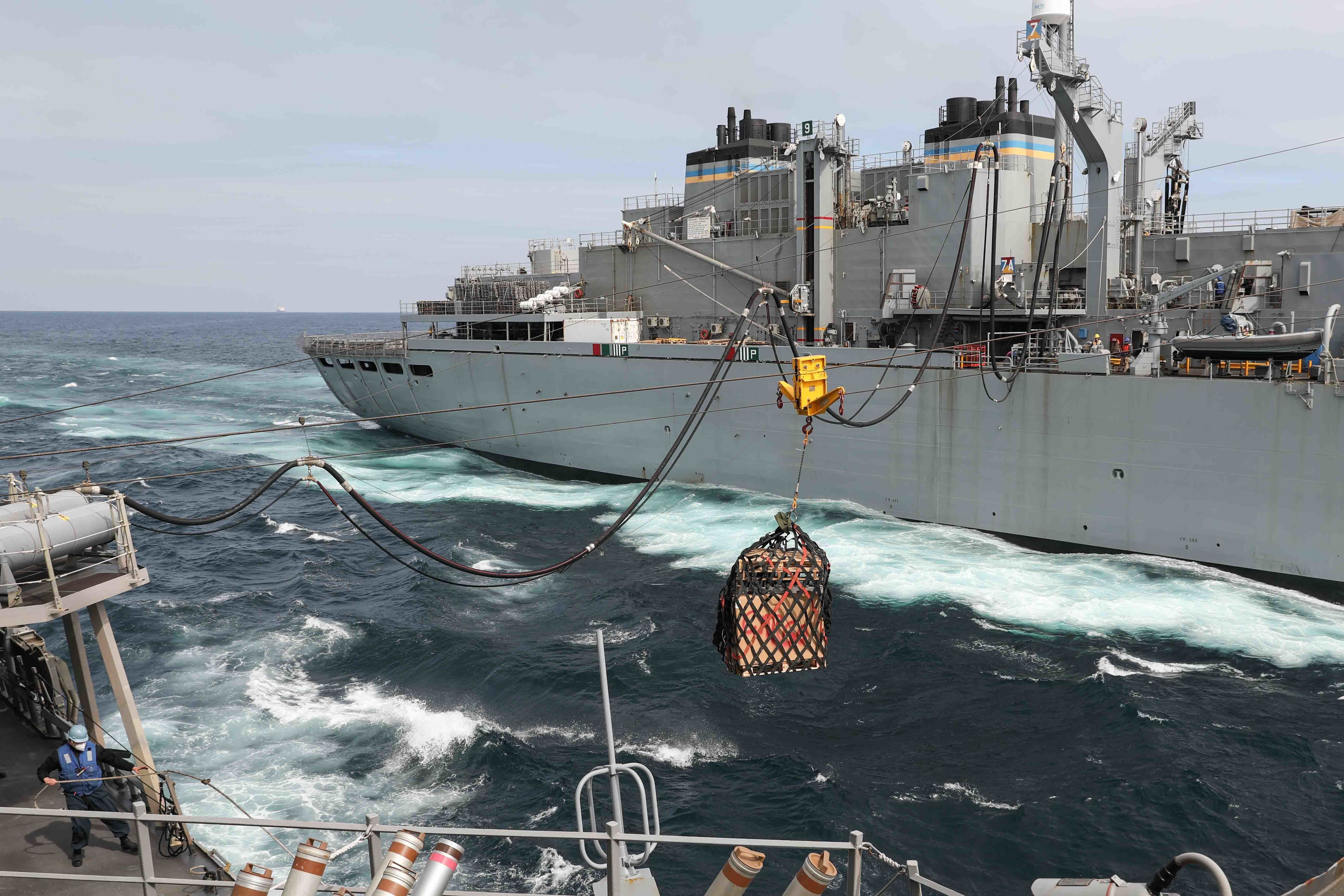 The Arleigh Burke-class guided-missile destroyer USS Ross (DDG 71), left, receives fuel and supplies during a replenishment-at-sea with the fast combat support ship USNS Supply (T-AOE 6) in the Atlantic Ocean.