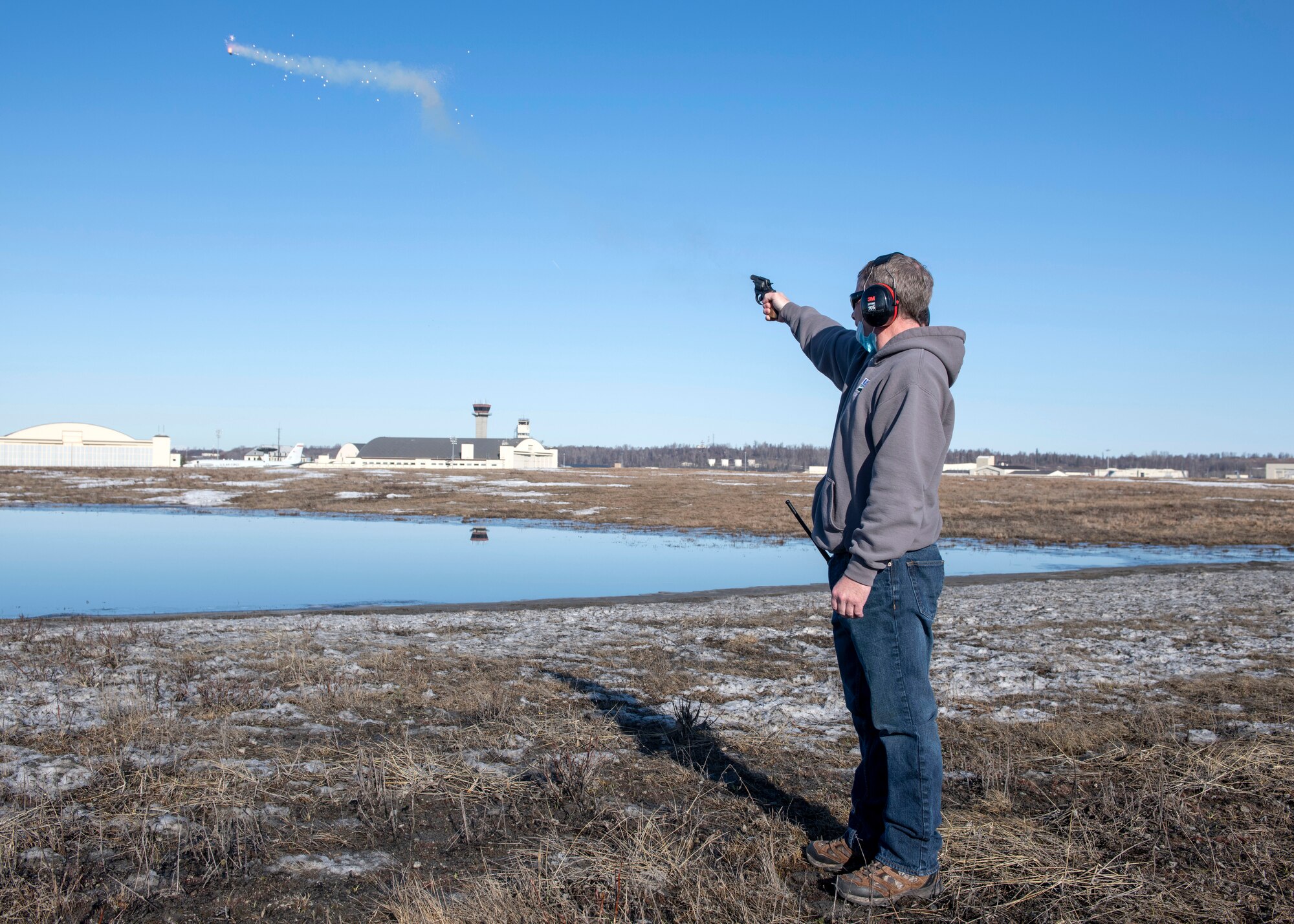 Jerry Morrill, the 3rd Wing Bird and Wildlife Strike Hazard project leader, uses pyrotechnic display to deter birds from the airfield at Joint Base Elmendorf-Richardson, Alaska, April 21, 2021. The BASH program uses multiple bird-deterrent methods to keep JBER’s aircraft flying without incident. In 1995, an E-3 Sentry Airborne Warning and Control System taking off collided with Canada geese; 24 crew members, including two Canadian armed forces personnel, were killed in the crash. Bird mitigation efforts have prevented such accidents since.