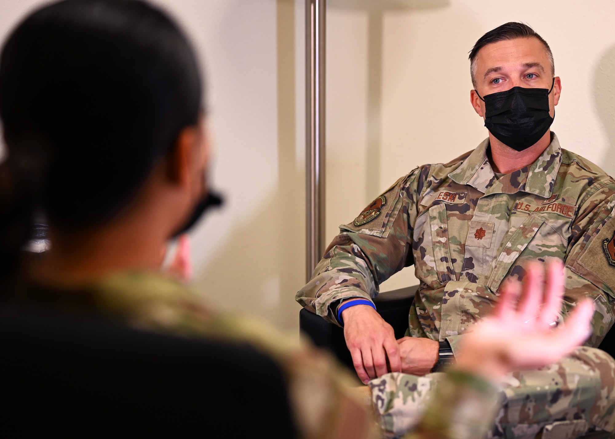 U.S. Air Force Maj. John Doleski, 17th Medical Group mental health flight commander, discusses the importance of mental health treatment with one of the technicians at the Ross Clinic on Goodfellow Air Force Base, Texas, April 19, 2021. Doleski strived to dispel the stigma around seeking mental health treatment within the Air Force. (U.S. Air Force photo by Airman 1st Class Michael Bowman)