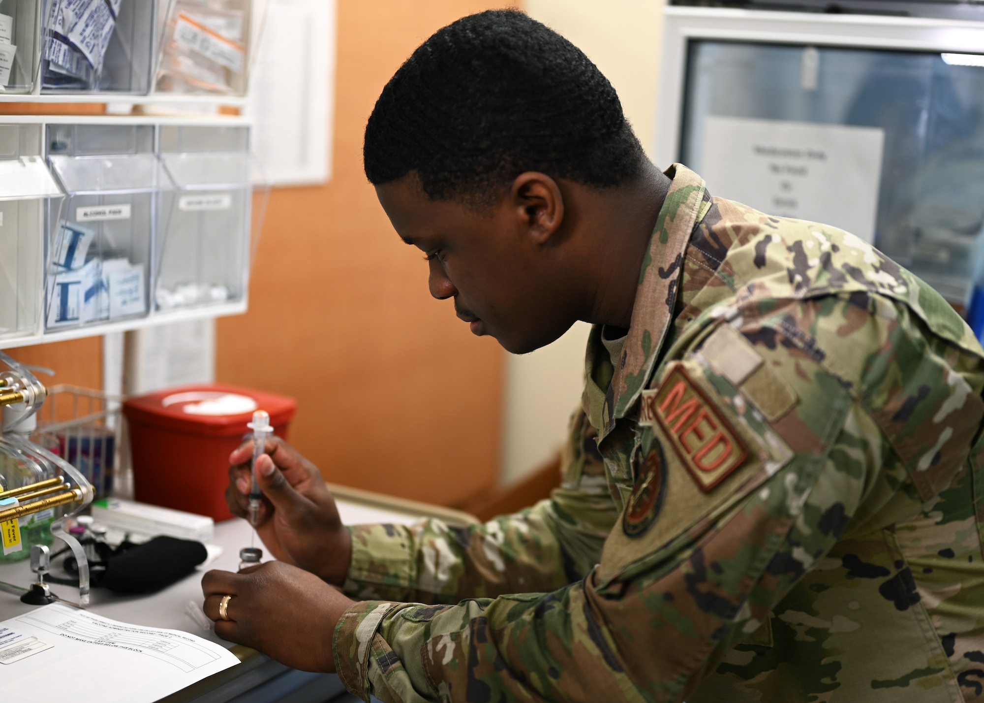 U.S. Air Force Senior Airman Micah Savage, 17th Medical Group immunizations technician, demonstrates how vaccines are prepared at the Ross Clinic on Goodfellow Air Force Base Texas, April 19, 2021. Savage performed his duties as an immunization technician to ensure the health and welfare of all Goodfellow personnel. (U.S. Air Force photo by Airman 1st Class Michael Bowman)