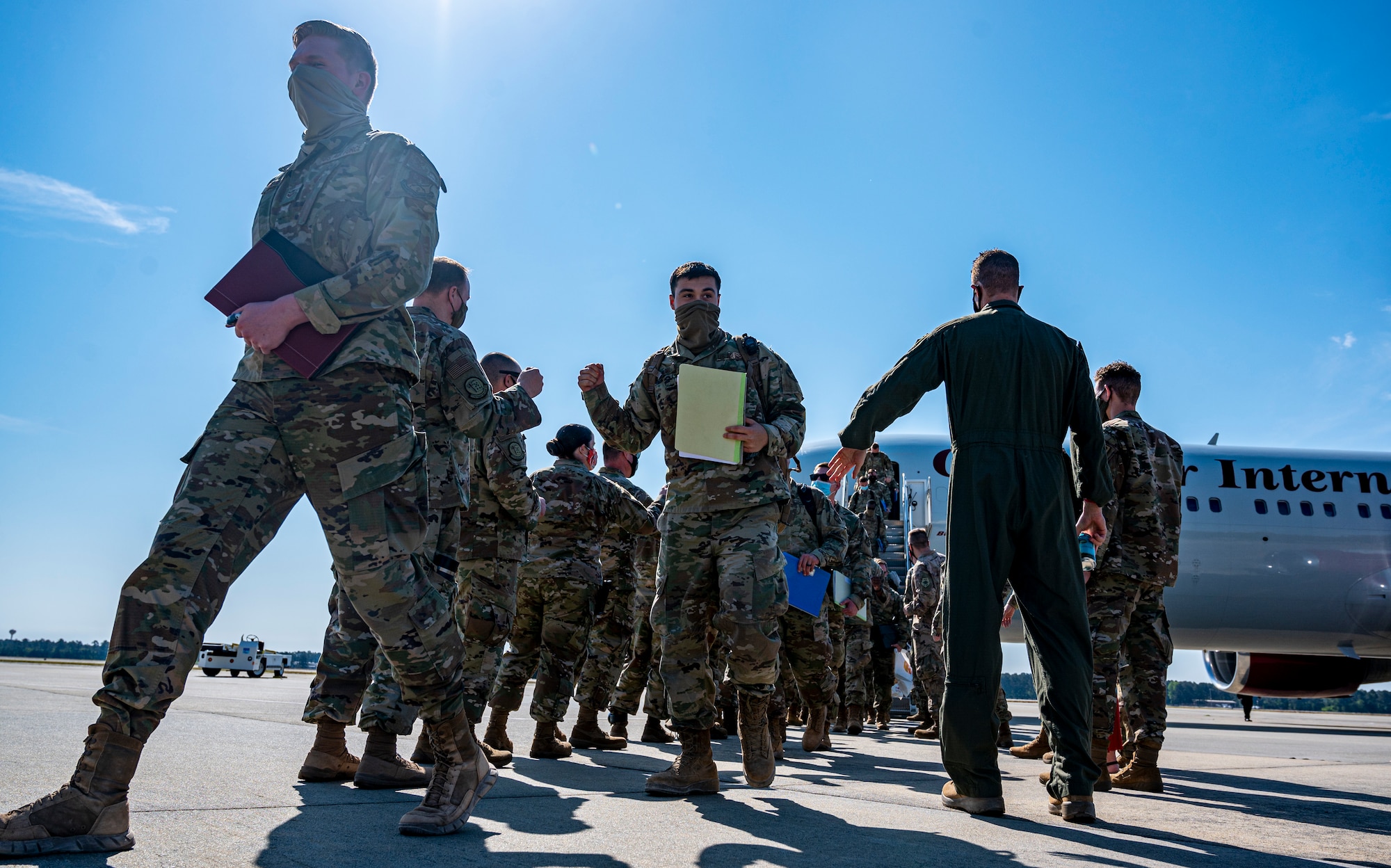 A photo of Airmen getting off of a plane.