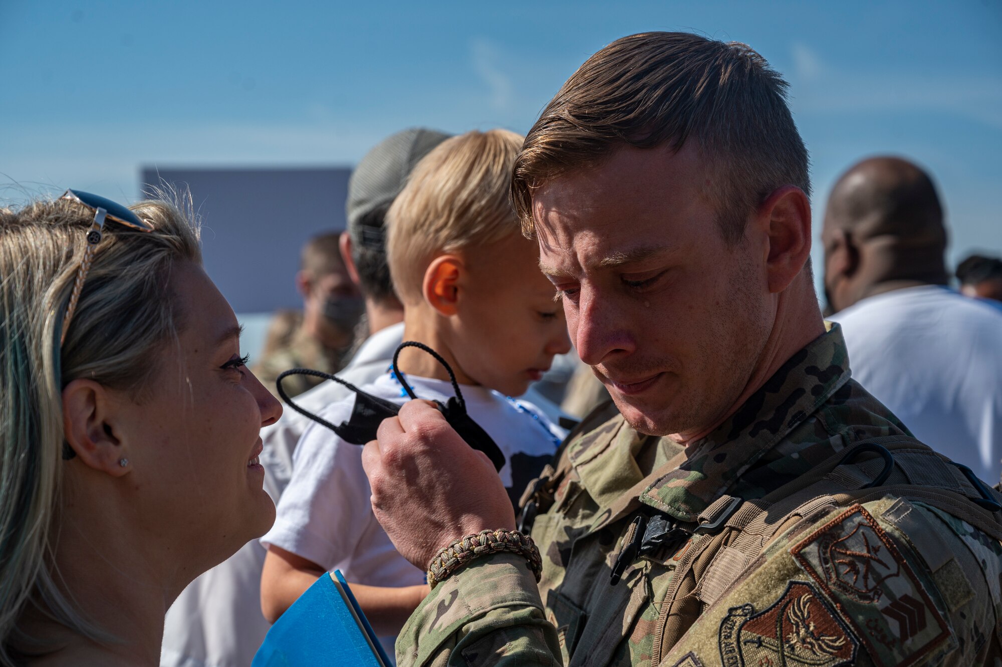 A photo of an Airman reuniting with his family.