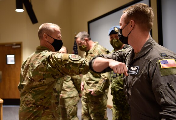 Gen. Kelly and Capt. Cummings bumping elbows.