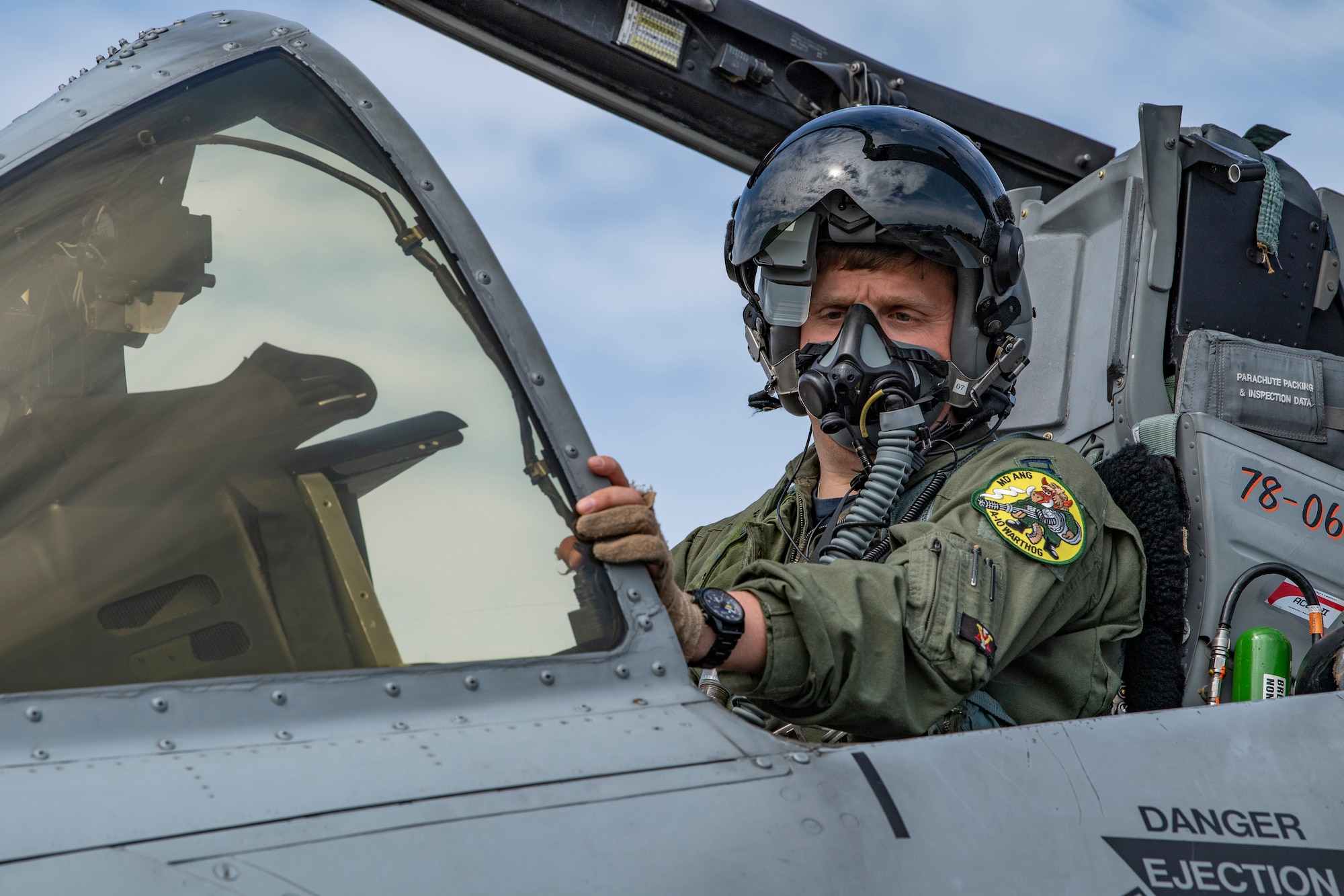 A photo of a pilot posing in a cockpit