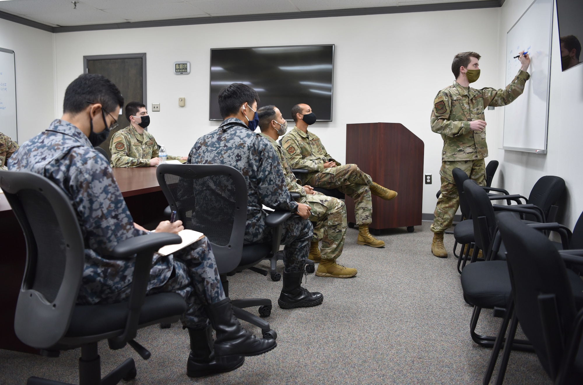 The 552nd Air Control Networks Squadron’s Mission Defense Team is comprised of cyber operators from a variety of different backgrounds, all contributing their unique skillsets to the team. When tasked for a cyber defense mission, a Mission Defense Team crew plans and briefs the mission before operating on E-3 or CRC cyber terrain, just like an aircrew. The 552nd ACNS has been the only Mission Defense Team in the Air Force to perform missions inside the skin of an aircraft, defending against adversaries in cyberspace. Senior Airman Gabriel Coleman, 552nd ACNS, describes the mission to Lt. Col. Akio Ohigashi and Capt. Shumpei Kawano from the Japanese Air Self-Defense Force and Capt. Ali Syed, Pacific Air Command A6, and Master Sgt. Christopher Bailey, PACAF A3. (Air Force photo by Kimberly Woodruff)