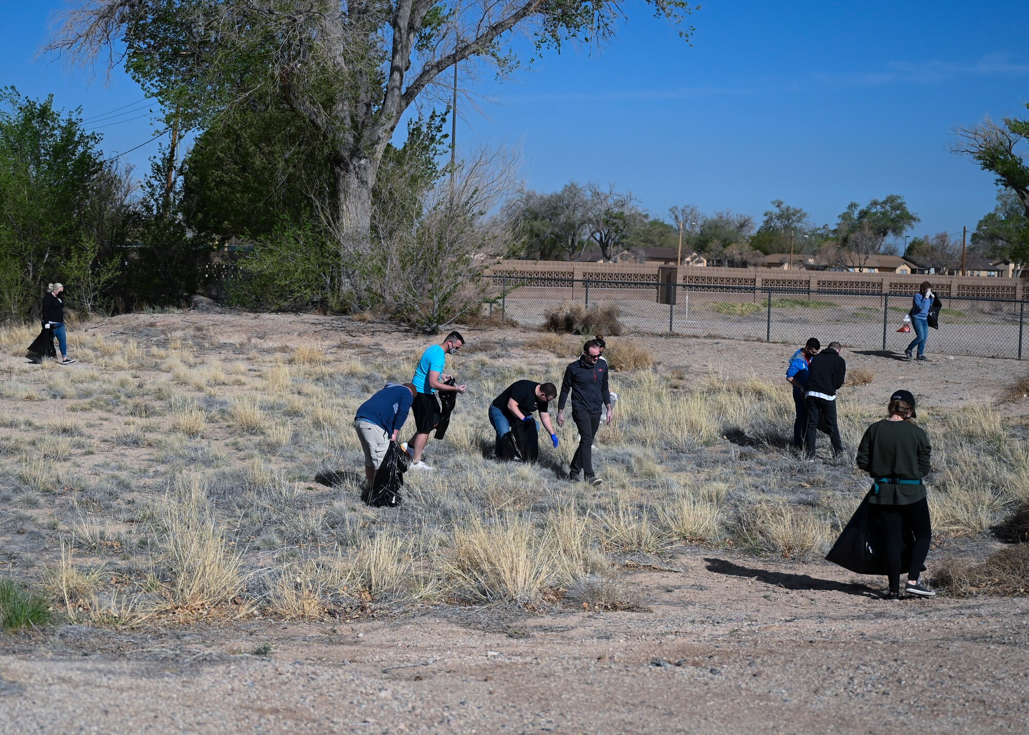 Members of Team Kirtland gather to pick up litter and debris.