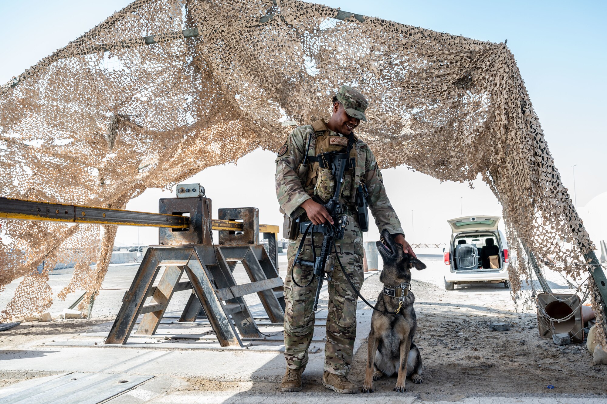 Staff Sgt. Michael Mandel pets his MWD.