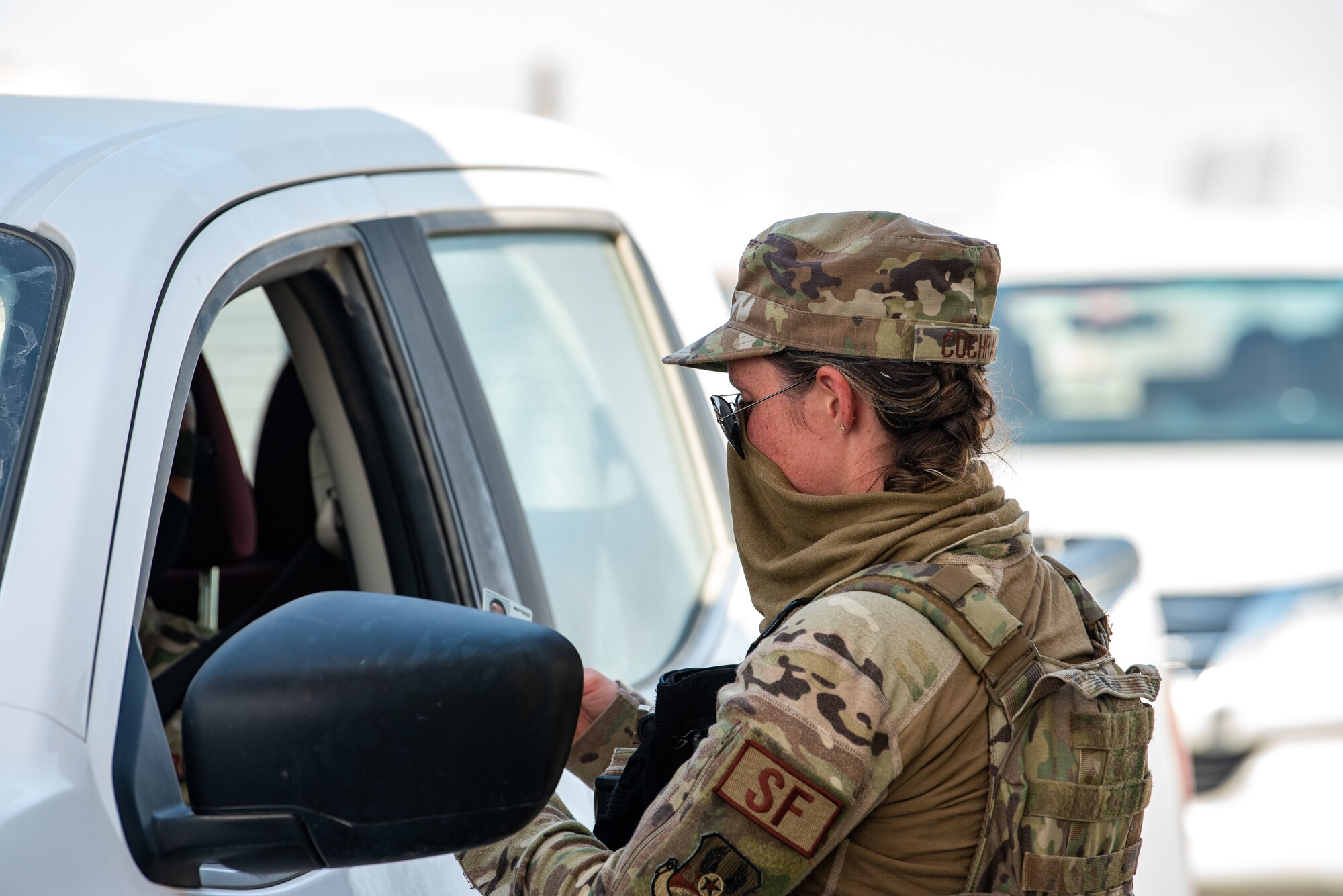 Senior Airman Samantha Cochran checks an identification card.