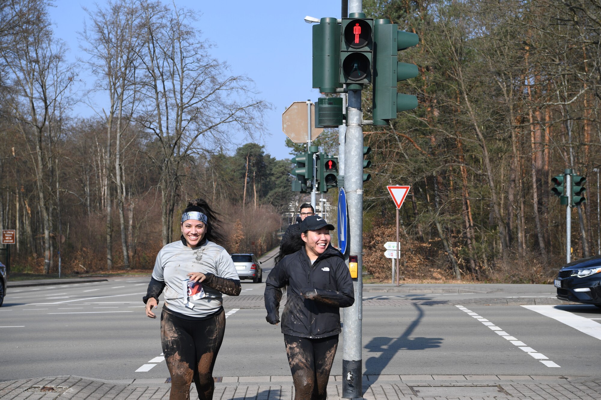 Airmen run across the street