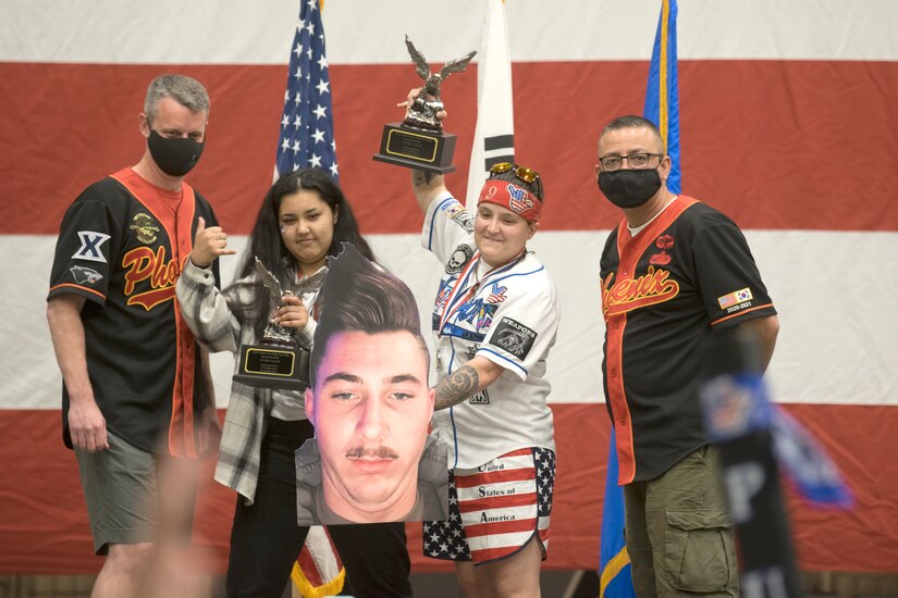 Staff Sgt. Yesenia Perez and A1C Natalie Navia along with a poster of Senior Airman Brandon Shaw wins the 2020 8th Maintenance Group Load Crew of the Year award at Kunsan Air Base, Republic of Korea March 24, 2021. This was part of Kunsan’s 2020 Maintenance Professional of the Year awards. (U.S. Air Force photo by Tech. Sgt. Will Bracy)