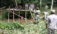 Belize Defence Force members train Louisiana National Guardsmen on constructing a hasty shelter during a jungle-warfare training exercise in Cayo, Belize, July 1, 2014. The training, part of the National Guard’s State Partnership Program, included jungle navigation, jungle survival, river and obstacle crossing and a culminating battalion-level jungle exercise.