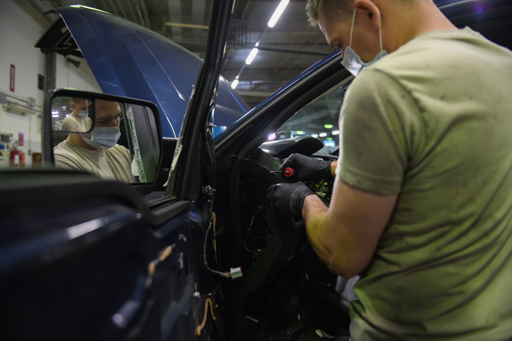 Airman 1st Class Korey Sarantopoulos, 31st Logistics Readiness Squadron vehicle maintenance technician, uses a screwdriver to repair a government vehicle at Aviano Air Base, Italy, April 20, 2021. Sarantopoulos repaired the heat, ventilation, and air conditioning (HVAC) system of a Ford F-150 truck. Sarantopoulos extracted multiple parts of the vehicle, such as the steering wheel and radio to repair the HVAC system. (U.S. Air Force photo by Senior Airman Ericka A. Woolever)