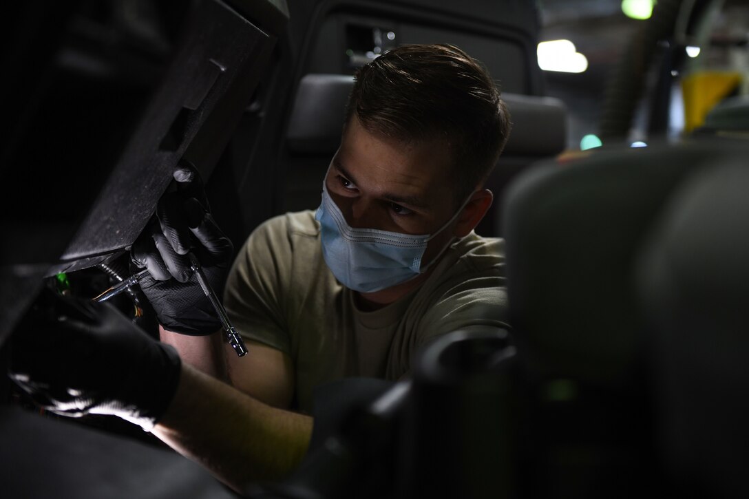 Airman 1st Class Korey Sarantopoulos, 31st Logistics Readiness Squadron vehicle maintenance technician, repairs a government vehicle at Aviano Air Base, Italy, April 20, 2021. Sarantopoulos repaired the heat, ventilation, and air conditioning system of a Ford F-150 truck. The 31st LRS delivers and sustains combat logistics readiness support through professional vehicle, supply and fuels management. (U.S. Air Force photo by Senior Airman Ericka A. Woolever)