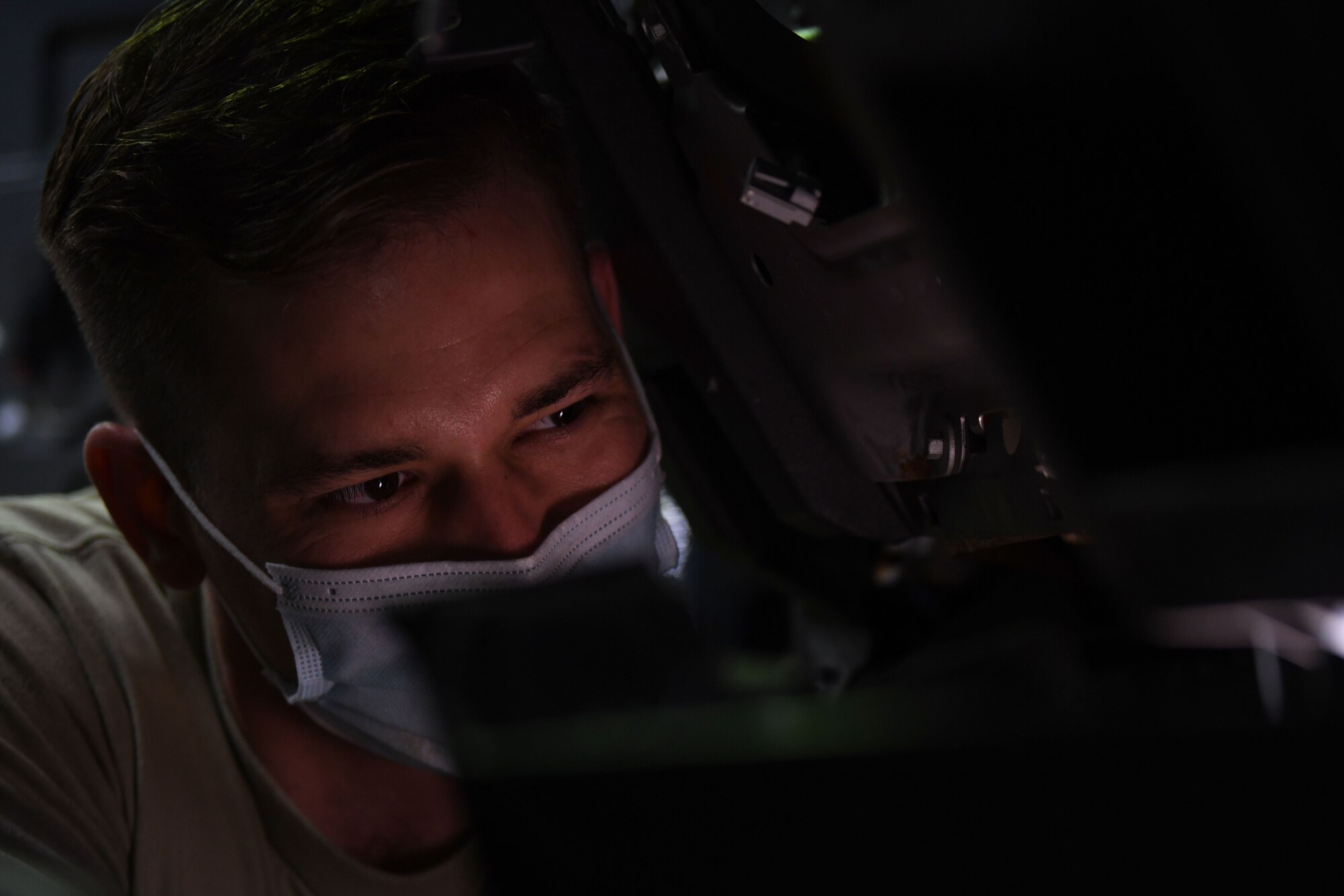 Airman 1st Class Korey Sarantopoulos, 31st Logistics Readiness Squadron vehicle maintenance technician, uses a flashlight to inspect a Ford F-150 at Aviano Air Base, Italy, April 20, 2021. Sarantopoulos repaired the heat, ventilation, and air conditioning (HVAC) system of a Ford F-150 truck. The HVAC system took approximately eight hours to repair. (U.S. Air Force photo by Senior Airman Ericka A. Woolever.)
