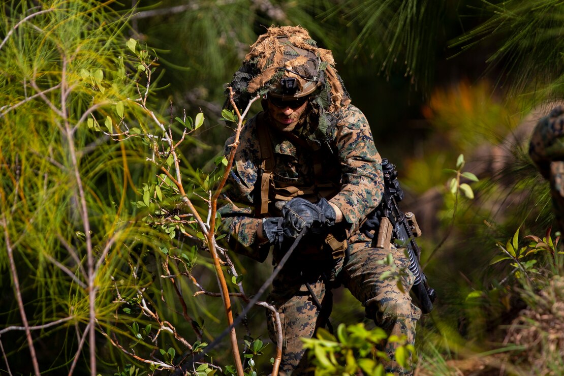 A U.S. Marine uses a repel rope as support and leverage to climb back up the steep incline at Kahuku Training Area, Hawaii, April 22.