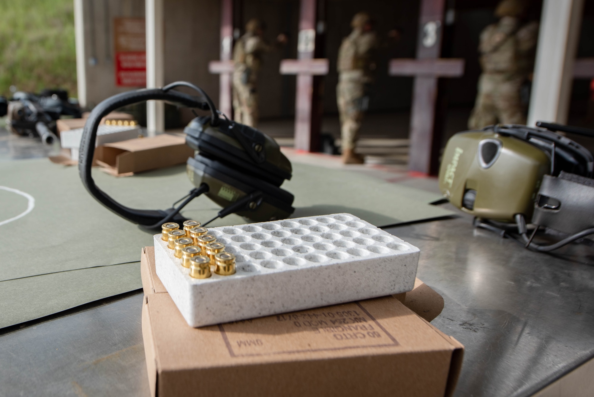 M-9 pistol ammunition and hearing protection sit on a table at the Incirlik Air Base, Turkey, combat arms training range, April 21, 2021. Combat Arms Training and Maintenance instructors qualify, maintain and inspect Air Force personnel and weapons to meet deployment and permanent change of station requirements. (U.S. Air Force photo by Senior Airman Derek Seifert)