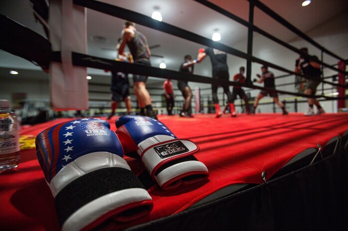 A pair of gloves are placed outside the boxing ring during a training session for U.S. Marine Corps boxers with the II Marine Expeditionary Force Martial Arts Center of Excellence boxing program on Marine Corps Base Camp Lejeune, N.C., April 20, 2021. The boxing program prepares II MEF Marines to compete in professional level matches through rigorous physical exercise and mental training. As a pilot program, it has already showcased four of its boxers in 2021 at the U.S.A. National Boxing Championship as well as more upcoming matches.