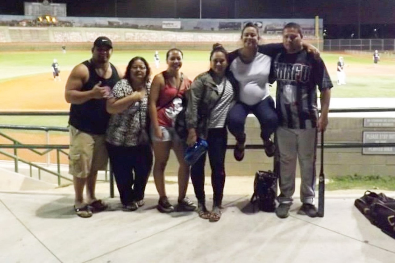 Softball star plays poses with friends.